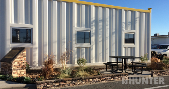 White custom modular building with yellow trim