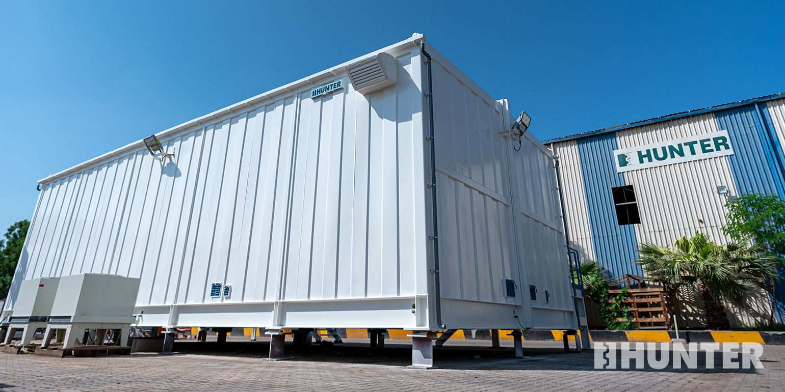 Gray remote instrument enclosure outside Hunter’s manufacturing facility