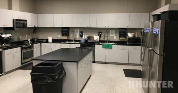 Kitchenette with cabinetry, oven, microwave and refrigerators in a custom modular building