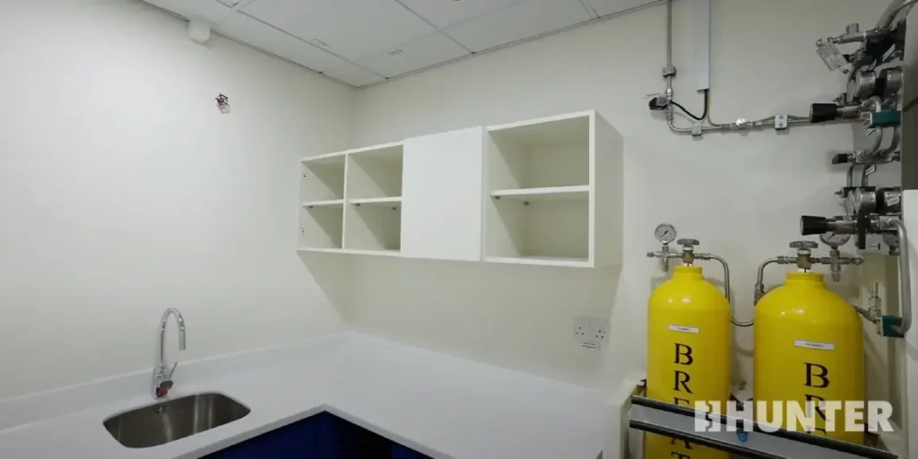 Interior view of custom modular guard house with shelving, sink and industrial hookups