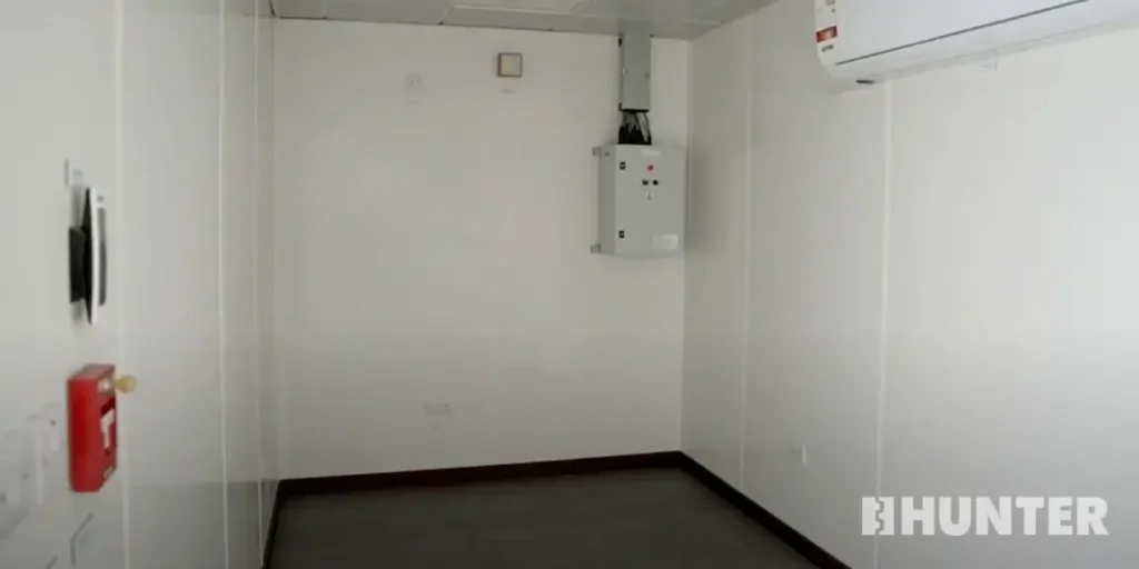 White interior of a prefabricated operator shelter with fire detection system