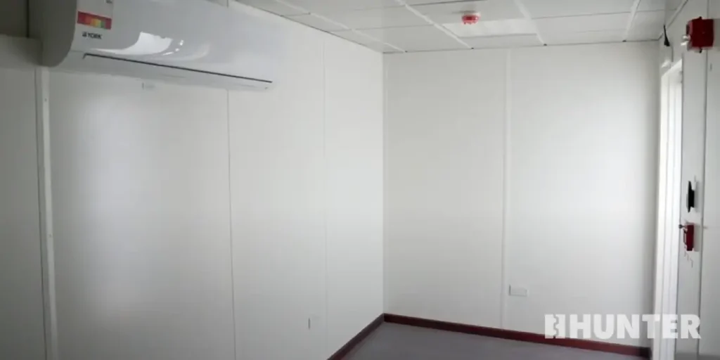 White interior of a prefabricated operator shelter with HVAC system
